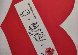 czerwone serce z papieru a na nim walentynkowy rebus