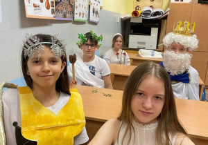 Przebrane uczennice na tle klasy i ławek
