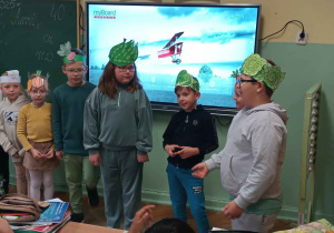 Dzieci w przepaskach z sylwetą wrzywa na tle ekranu