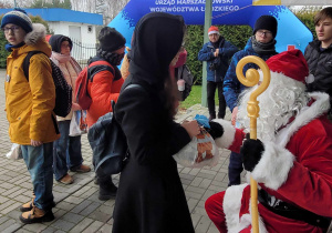 Mikołaj rozdaje upominki uczestnikom rajdu