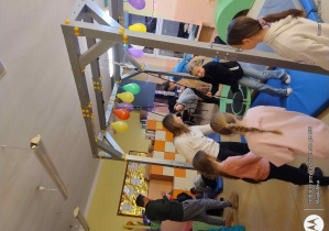 Dzieci bawią się z terapeutką w sali integracji sensorycznej